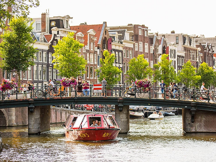 City Sightseeing Amsterdam boat under a bridge